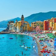 Beach In Camogli Lined By Pastel Colored Houses In Liguria, Italy, Southern Europe